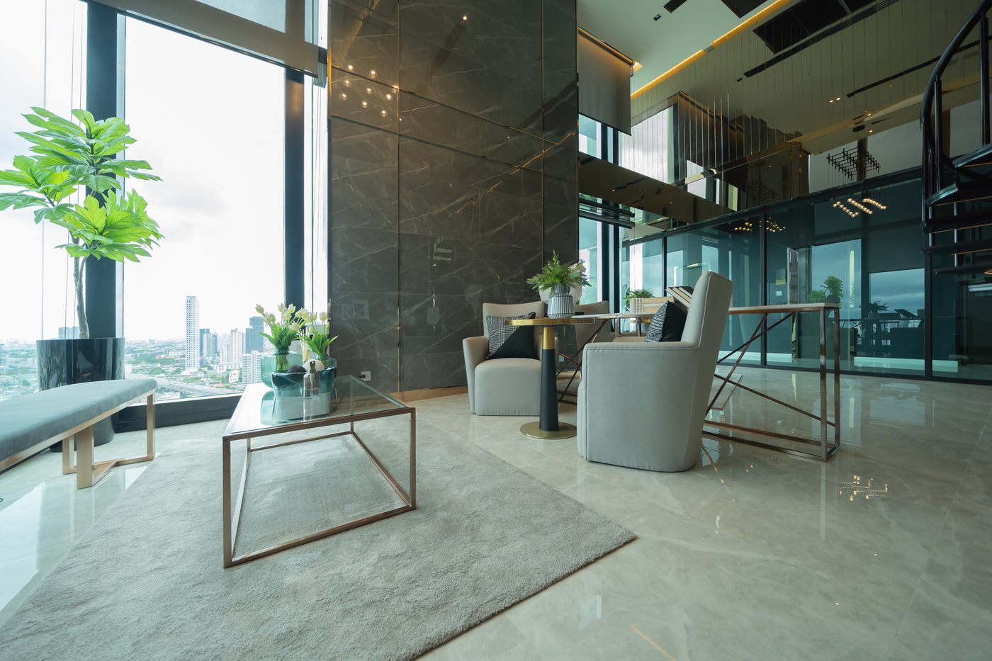 Lounge and reception area of a luxury high rise residential building with floor to ceiling windows overlooking the city skyline