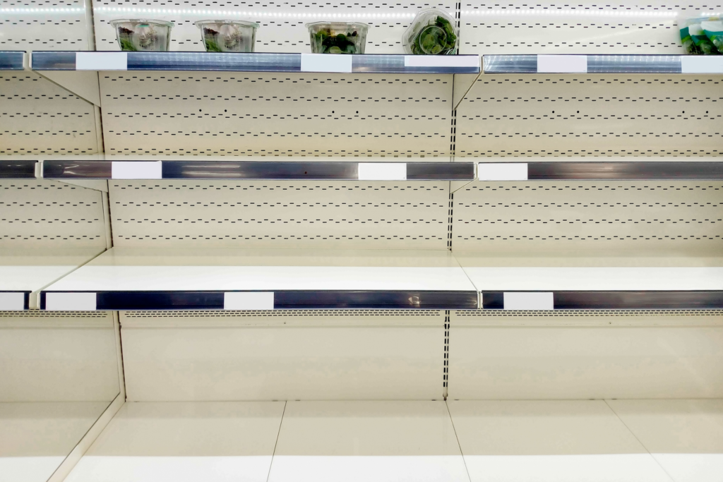 Stripped retail shelving after an organized retail crime hit, showing why retail security guards matter before the goods leave the store