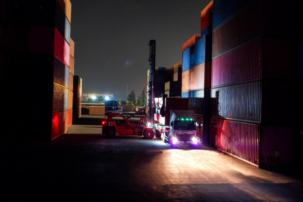 Loaded shipping containers in a dark yard at night, the quiet window holiday cargo theft crews target